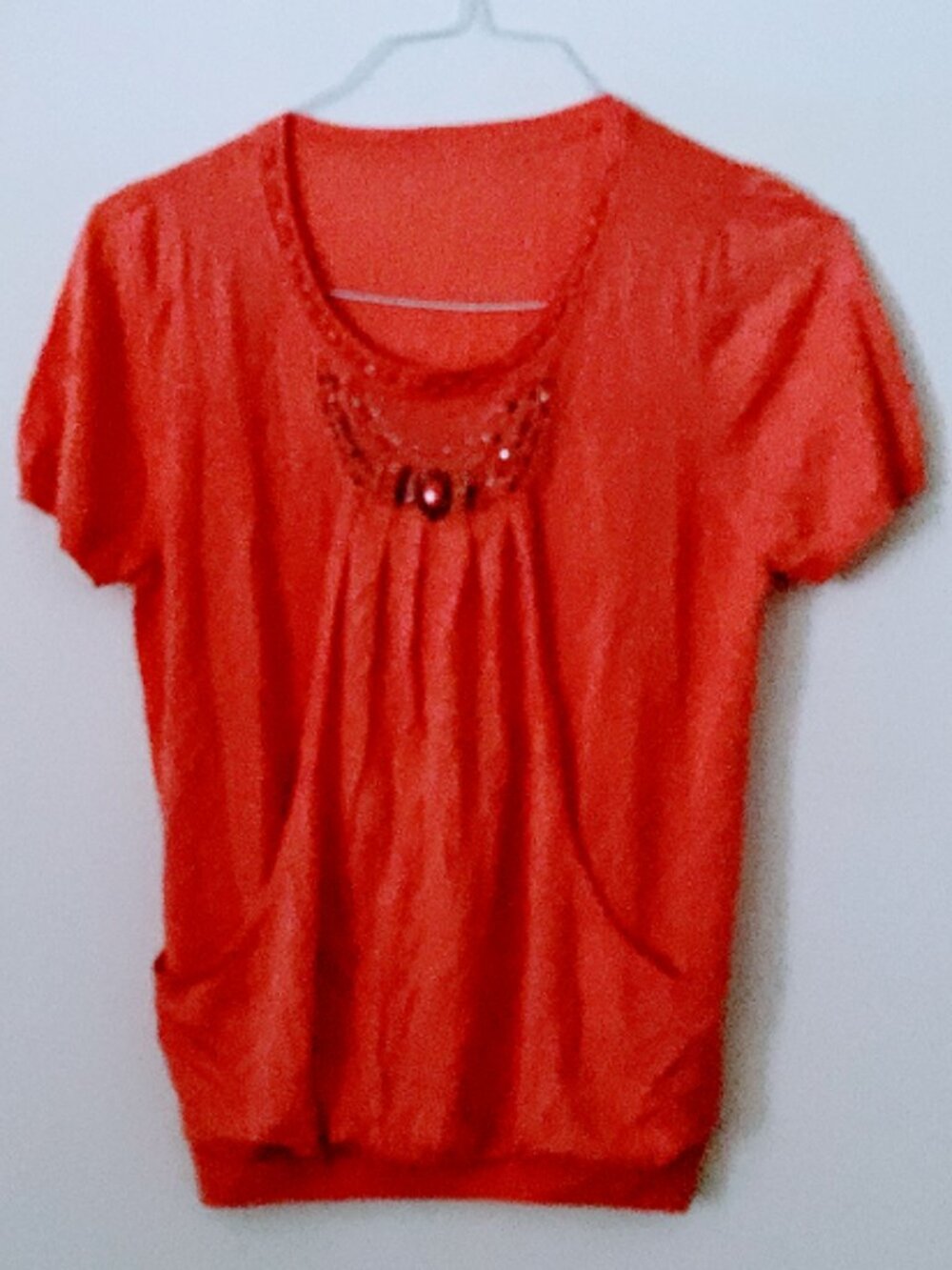 K-0001 short-sleeved top in a coral-orange hue
